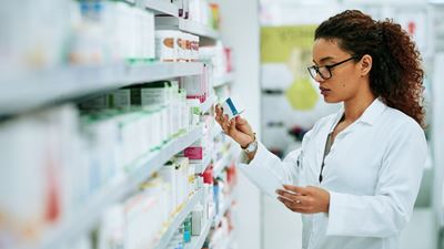 Pharmacist searching drugs on the shelf