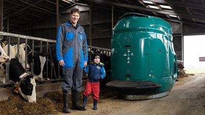 Theo van der Zwaag from the Netherlands stands in front of a GEA automated feeding robot.