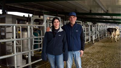 Josep Masramón and his daughter stand in front of their GEA batch milking installation.